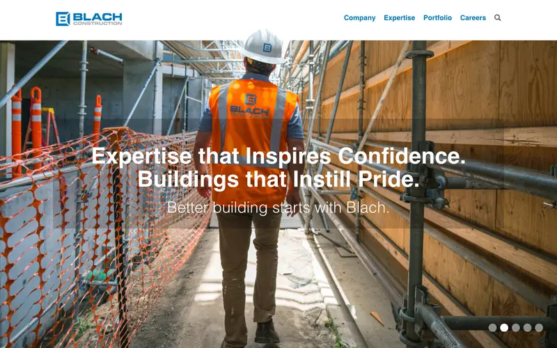 The Blach Construction homepage with a worker in a branded orange vest walking through a site