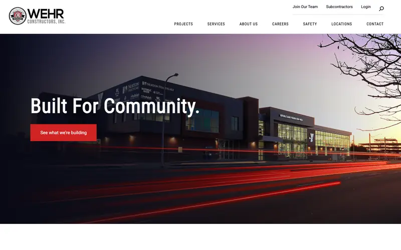 The WEHR Constructors homepage with a lit building at dusk and the headline Built For Community