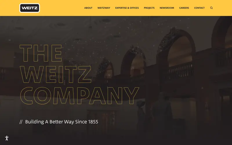 The Weitz Company homepage with outlined yellow lettering over a dark interior